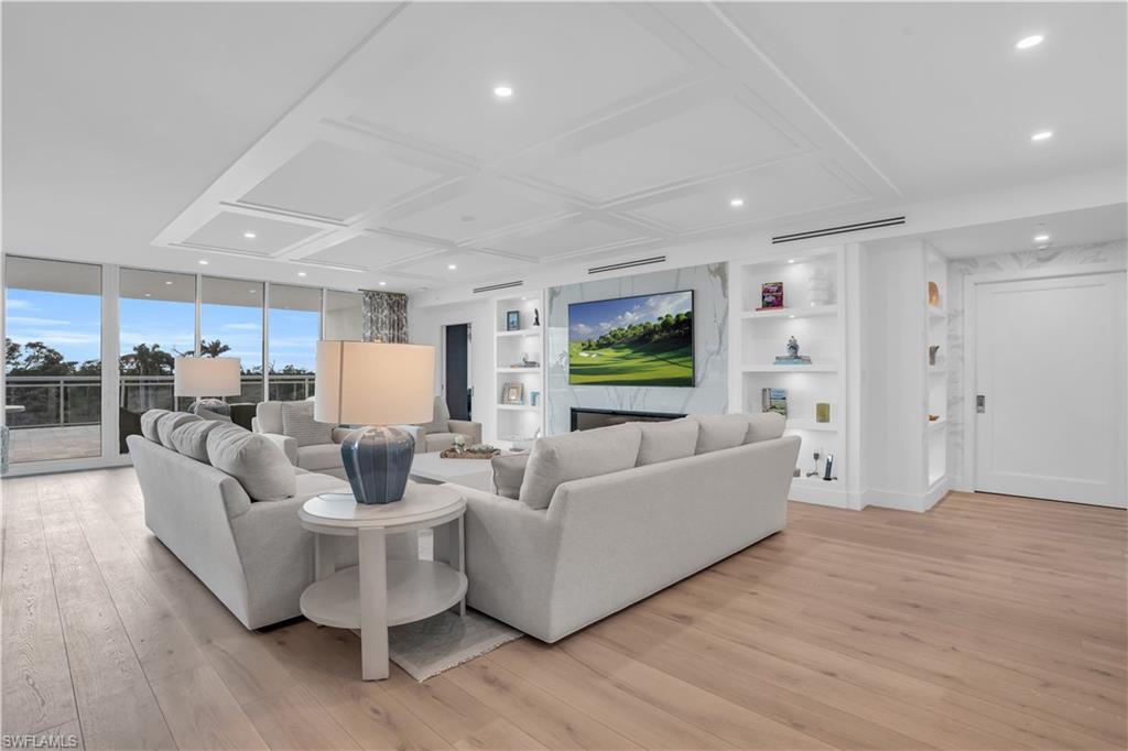 13945 Old Coast Road, Unit 301 Naples, FL 34110 - Photo 5 of 30 a living room with furniture and a wooden floor