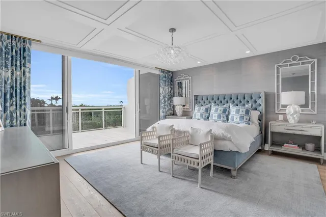 a bed sitting in a spacious bedroom next to a window