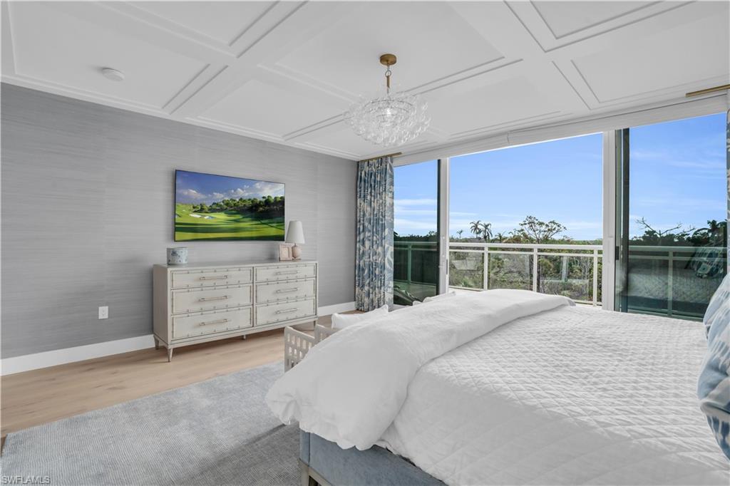 13945 Old Coast Road, Unit 301 Naples, FL 34110 - Photo 10 of 30 a large bed sitting in a room next to a window