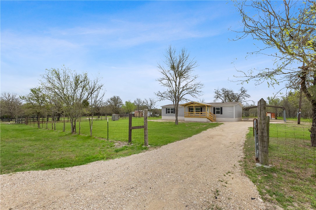 1014 Doe Run Road Caldwell, TX 77836 - Photo 1 of 23 a view of a house with a yard and palm trees