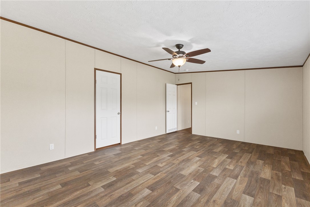 1014 Doe Run Road Caldwell, TX 77836 - Photo 14 of 23 an empty room with a ceiling fan and a window