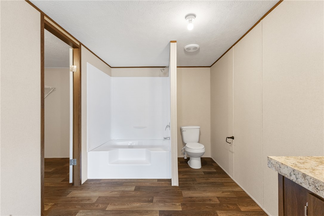 1014 Doe Run Road Caldwell, TX 77836 - Photo 16 of 23 a bathroom with a granite countertop shower and a toilet