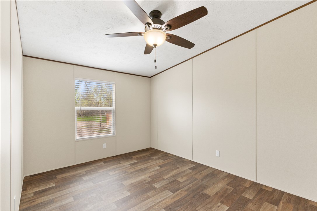 1014 Doe Run Road Caldwell, TX 77836 - Photo 18 of 23 an empty room with window and ceiling fan