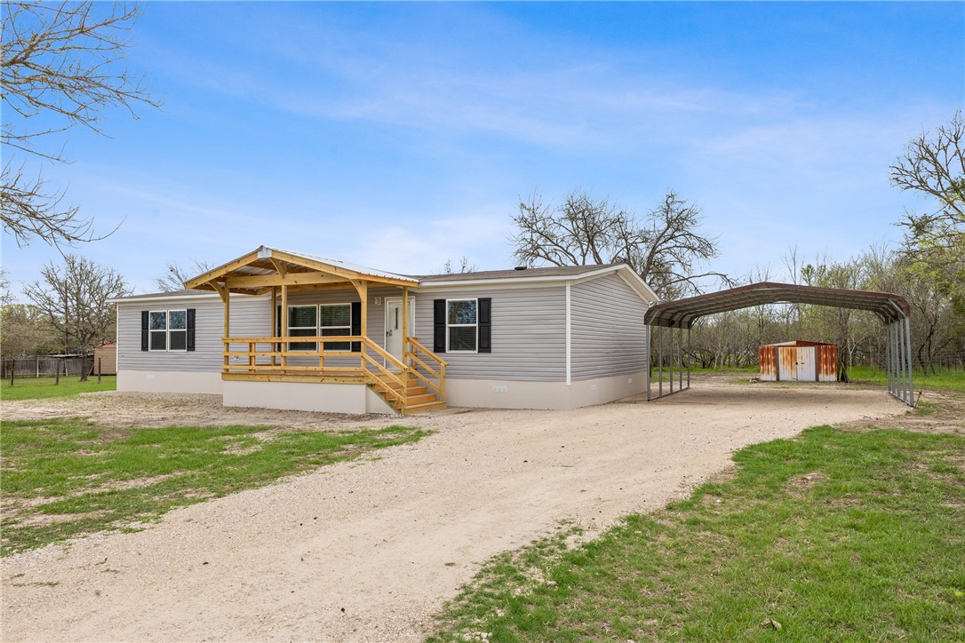 1014 Doe Run Road Caldwell, TX 77836 - Photo 2 of 23 a front view of a house with a yard and garage
