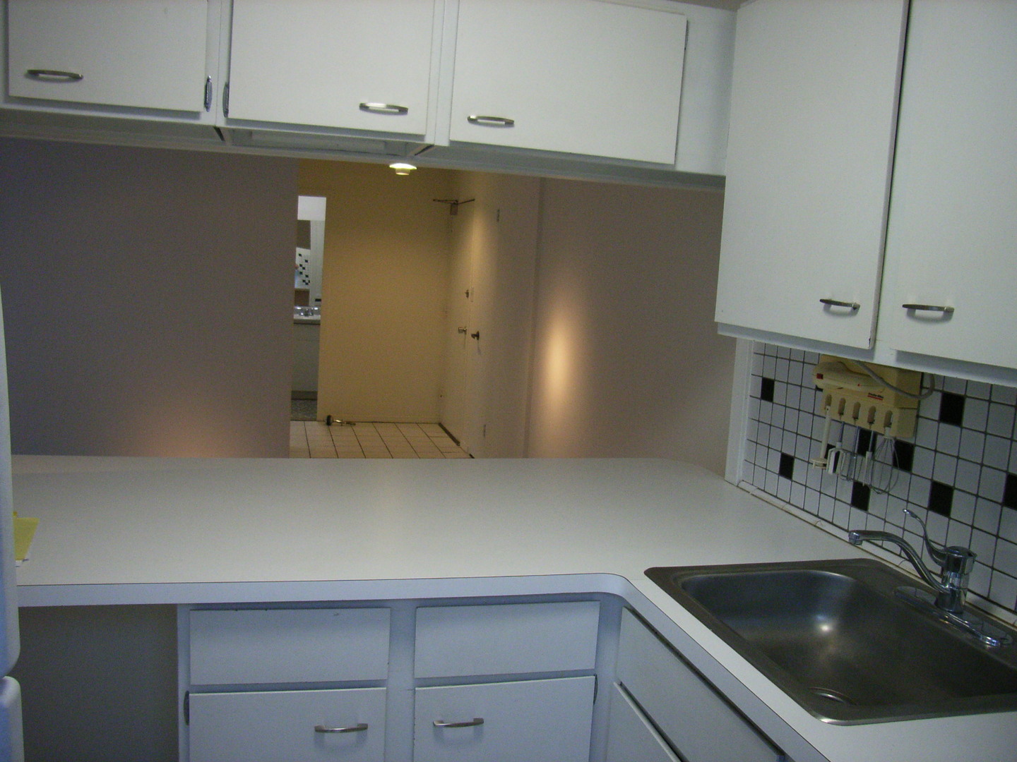 700 West Bittersweet Place, Unit 207 Chicago, IL 60613 - Photo 5 of 11 a kitchen with a sink and cabinets
