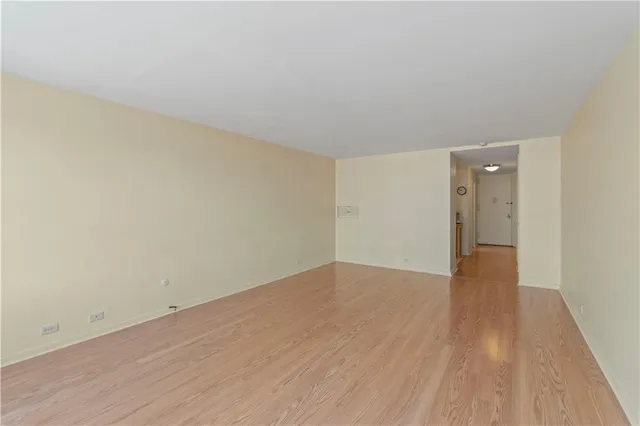 a view of an empty room and wooden floor