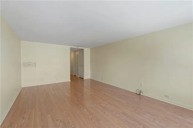 a view of an empty room and wooden floor