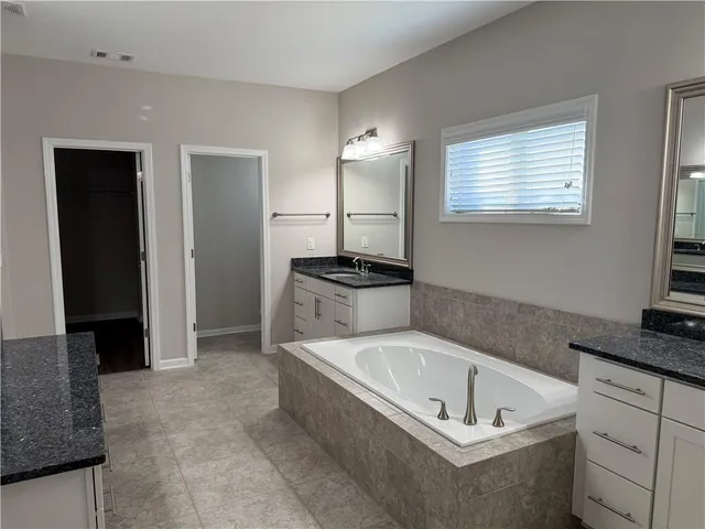 a bathroom with a bathtub and a sink