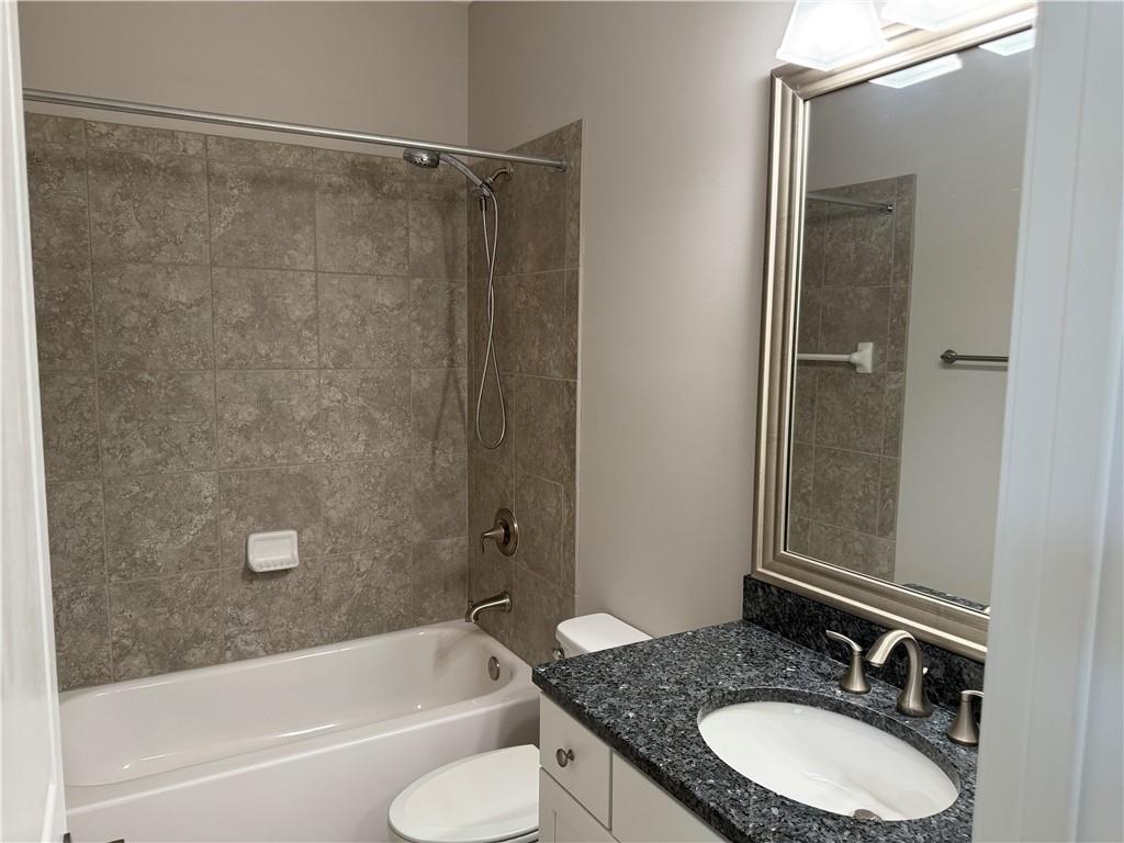 5670 Bridleton Crossing Suwanee, GA 30024 - Photo 19 of 23 a bathroom with a granite countertop sink toilet and shower