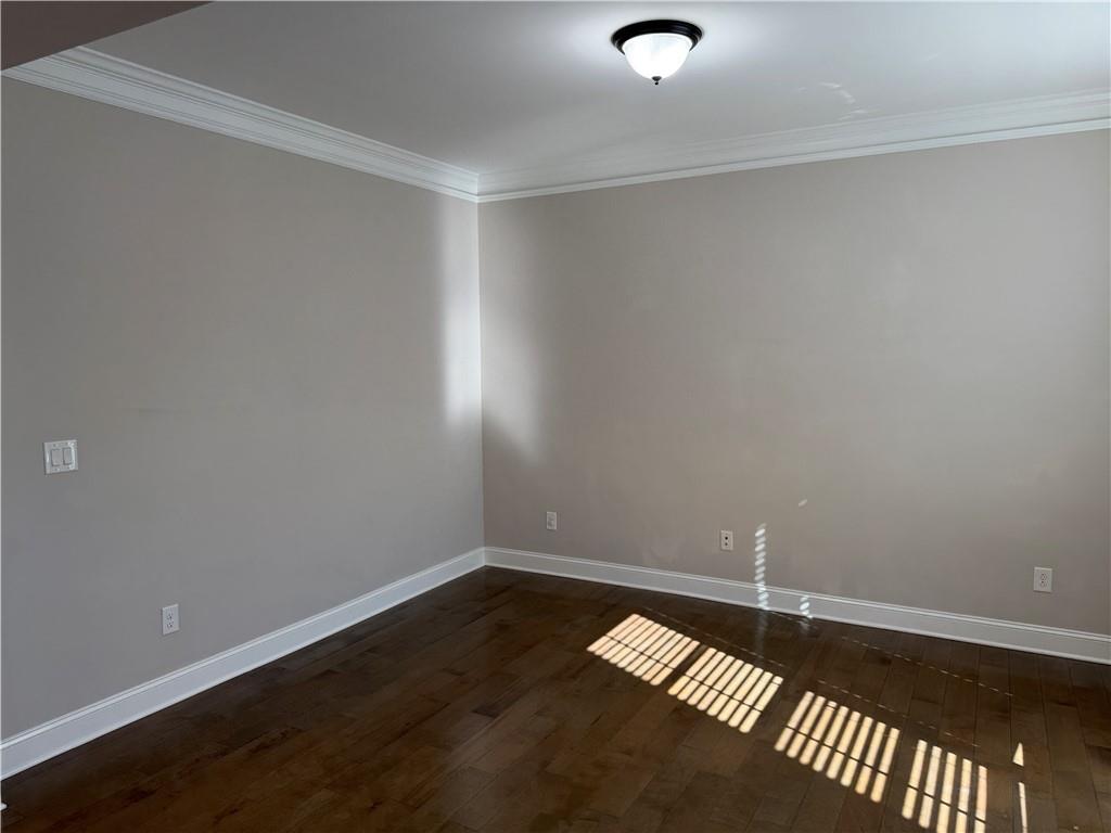 5670 Bridleton Crossing Suwanee, GA 30024 - Photo 4 of 23 a view of an empty room and wooden floor