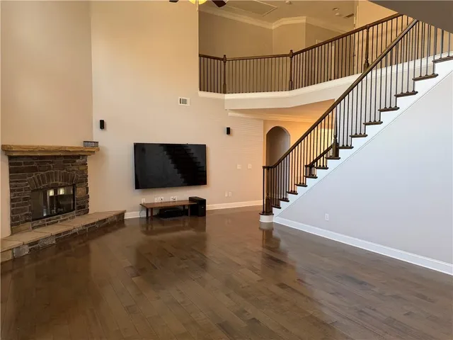 a view of a livingroom with wooden floor and a fireplace