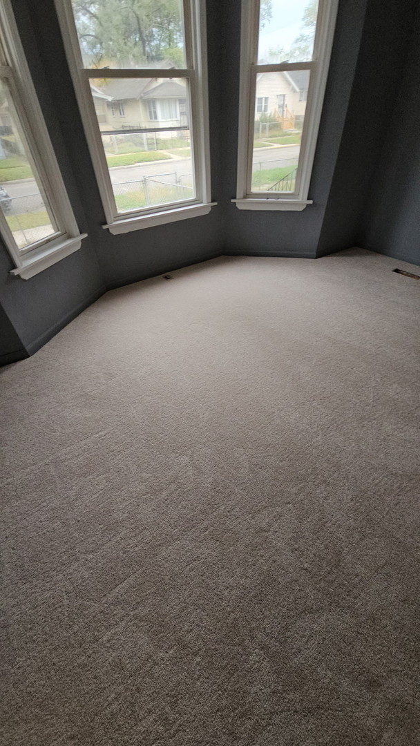 663 West 117th Place, Unit 2 Chicago, IL 60628 - Photo 2 of 6 an empty room with a window