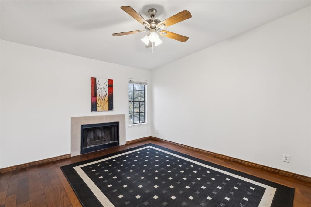 4748 Old Bent Tree Lane, Unit 1808 Dallas, TX 75287 - Photo 4 of 28 a living room with furniture and a fireplace