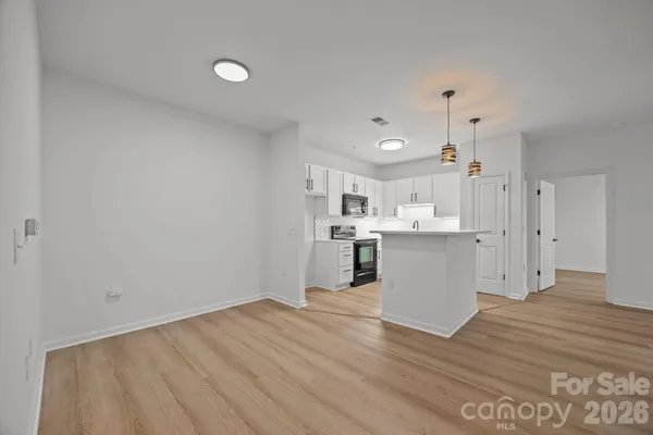 a view of kitchen with wooden floor and electronic appliances