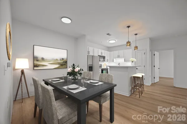 a view of a dining room with furniture and wooden floor