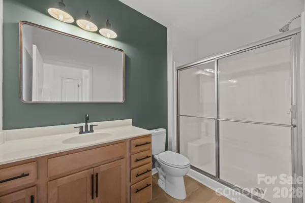 a bathroom with a sink toilet and mirror