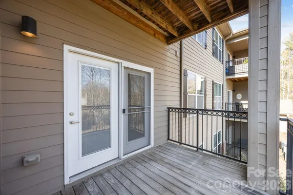 a kitchen with stainless steel appliances granite countertop a sink a stove a refrigerator and white cabinets