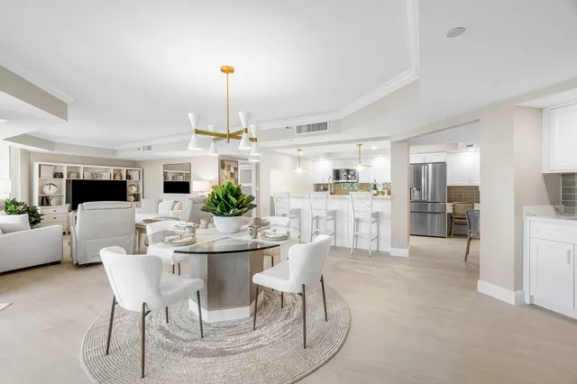 a living room with furniture a flat screen tv and a window