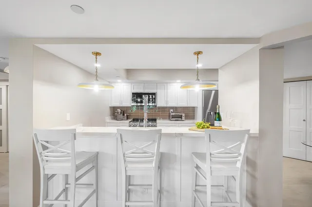 a kitchen with a sink and a large window