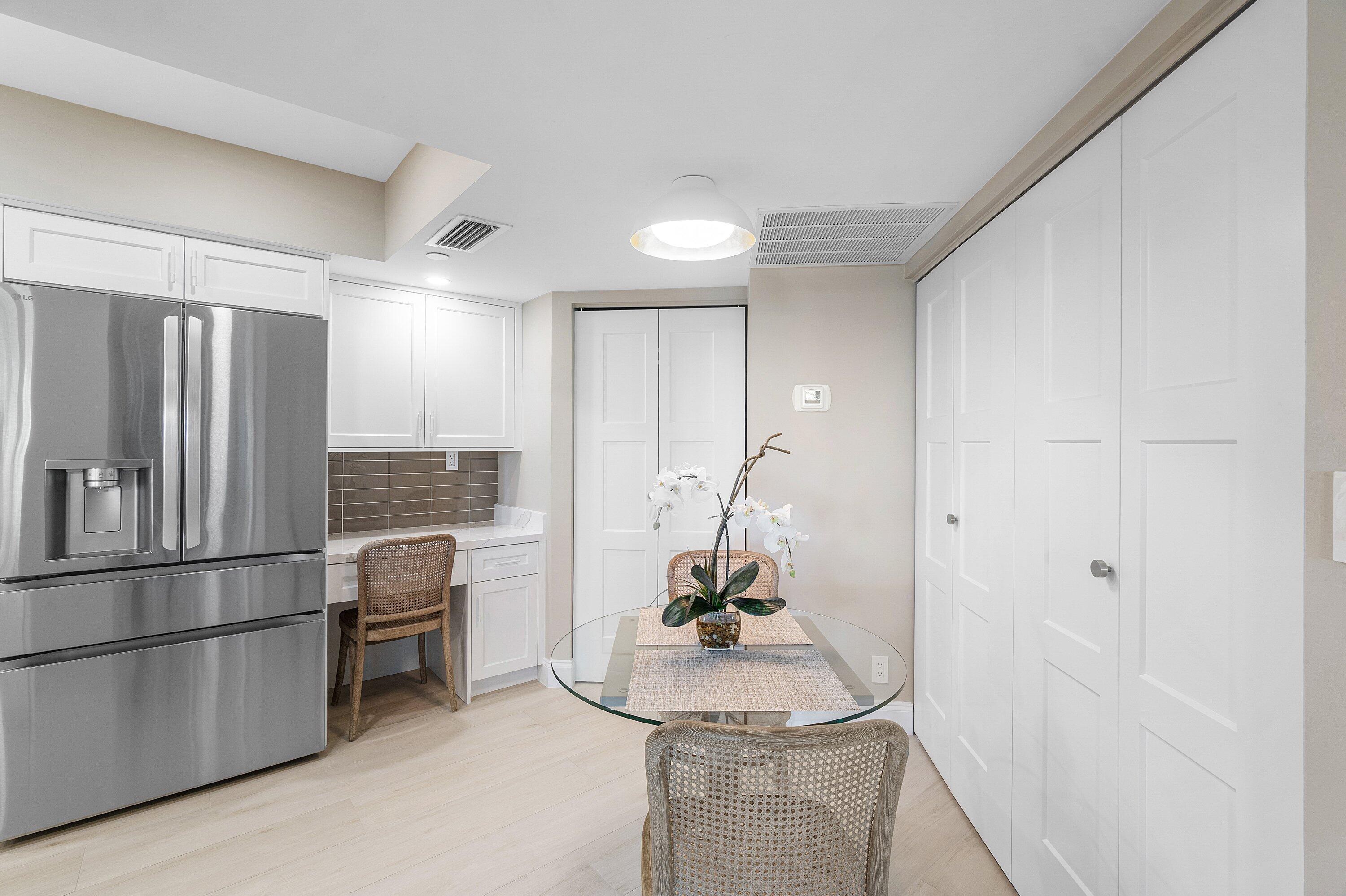 100 Southeast 5th Avenue, Unit 404 Boca Raton, FL 33432 - Photo 13 of 46 a kitchen with a refrigerator and a sink