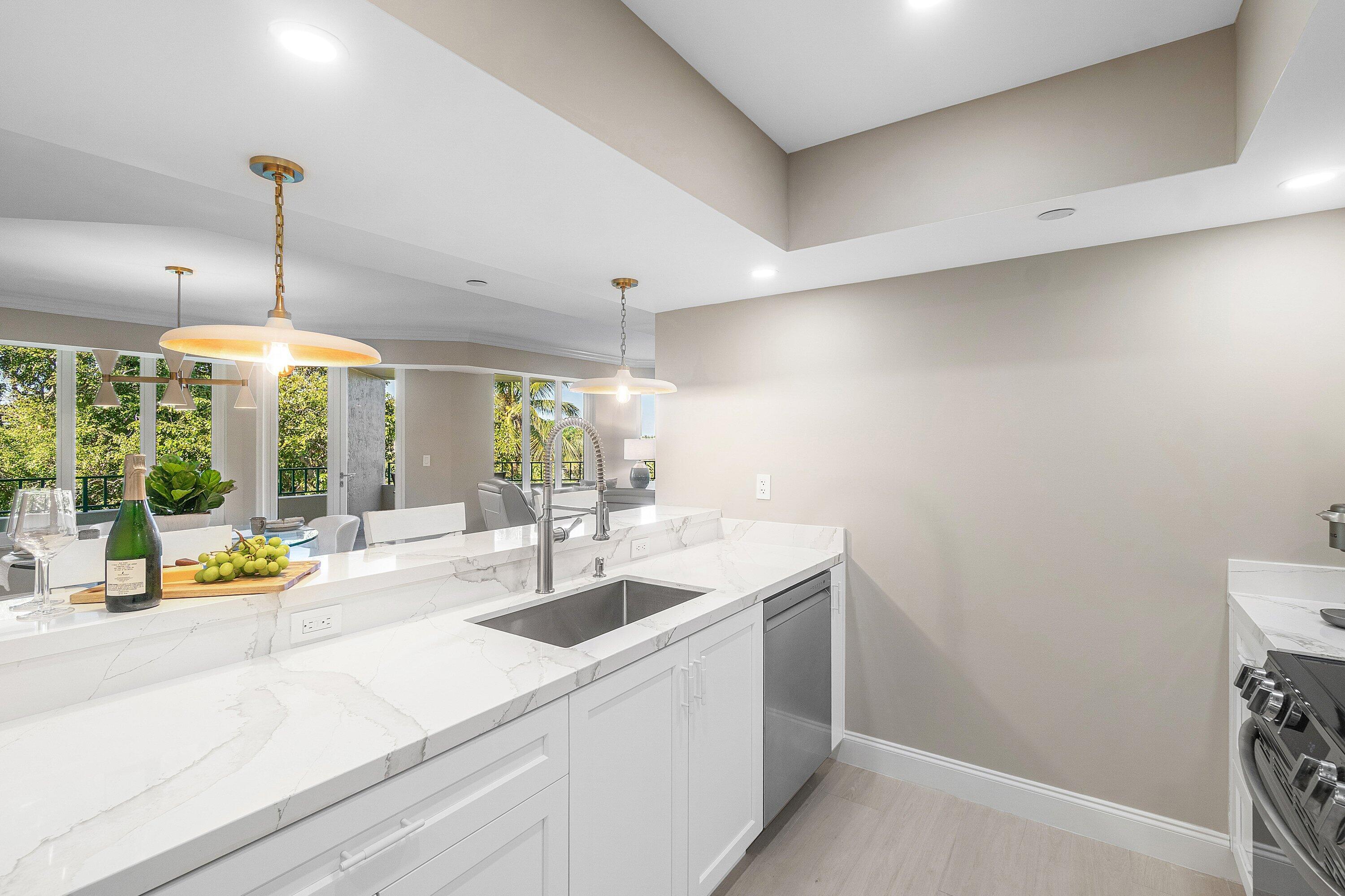 100 Southeast 5th Avenue, Unit 404 Boca Raton, FL 33432 - Photo 16 of 46 a kitchen with a sink and a large window