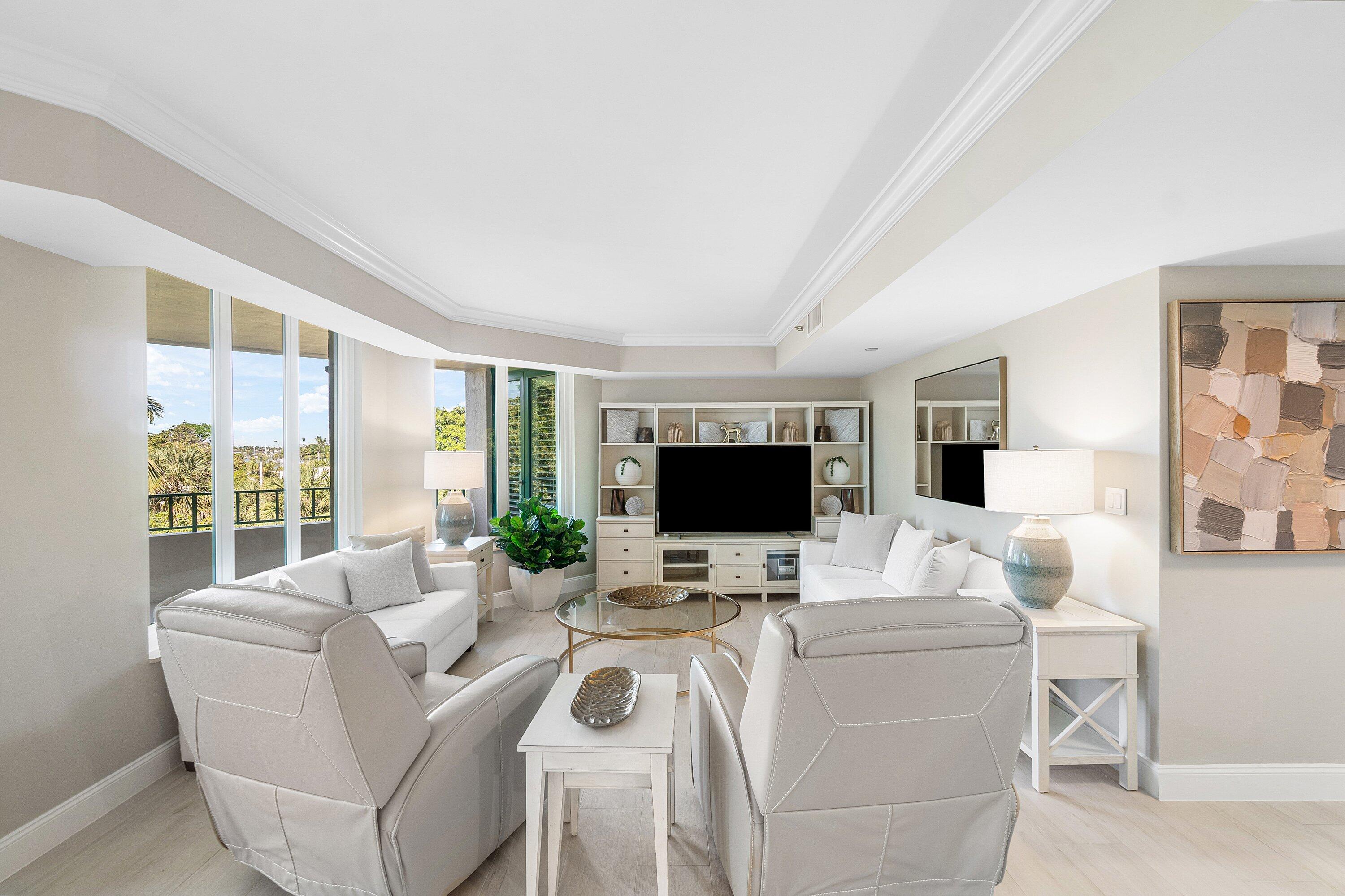 100 Southeast 5th Avenue, Unit 404 Boca Raton, FL 33432 - Photo 18 of 46 a living room with furniture and a flat screen tv