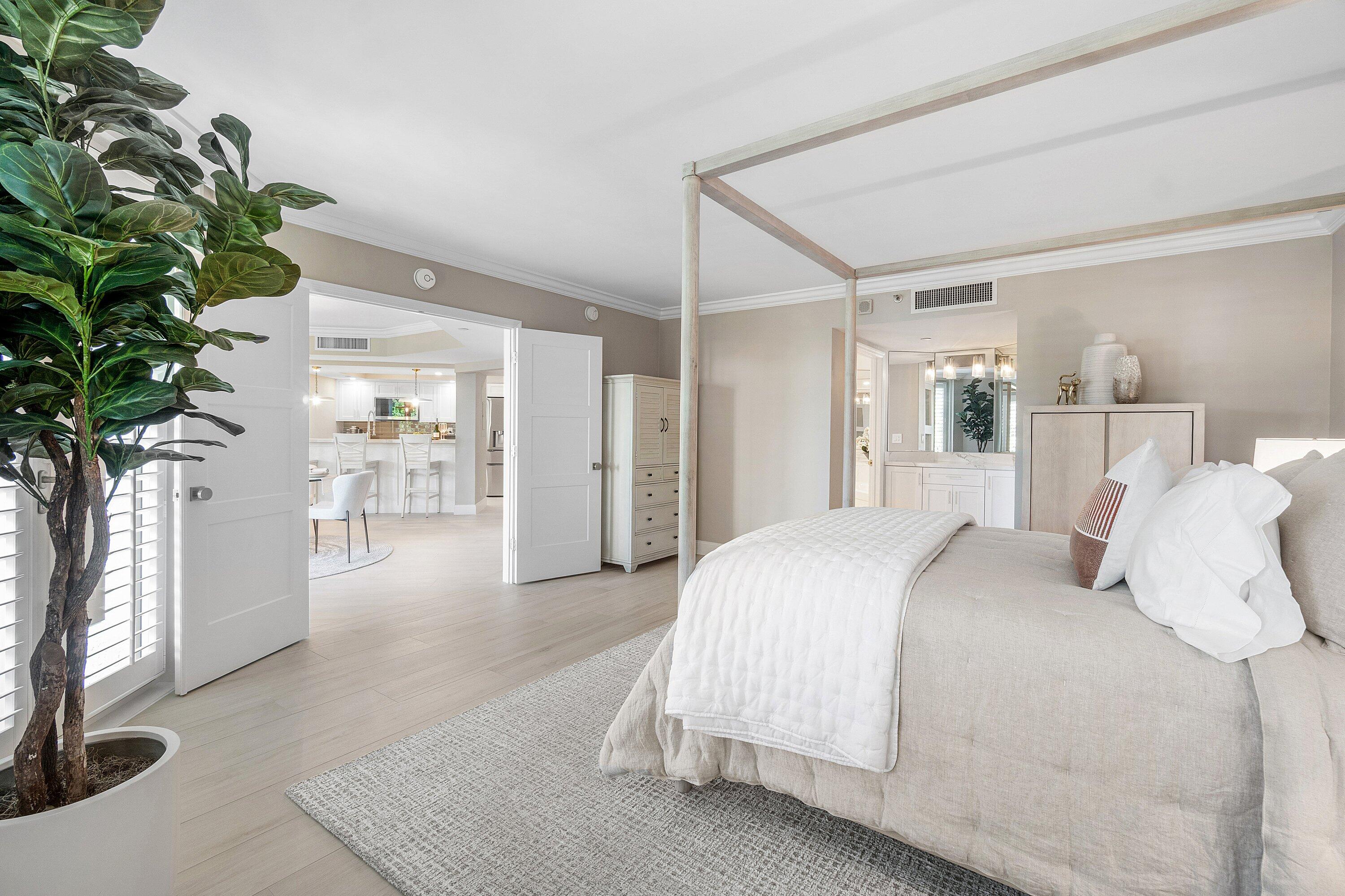 100 Southeast 5th Avenue, Unit 404 Boca Raton, FL 33432 - Photo 21 of 46 a bedroom with a bed and a potted plant