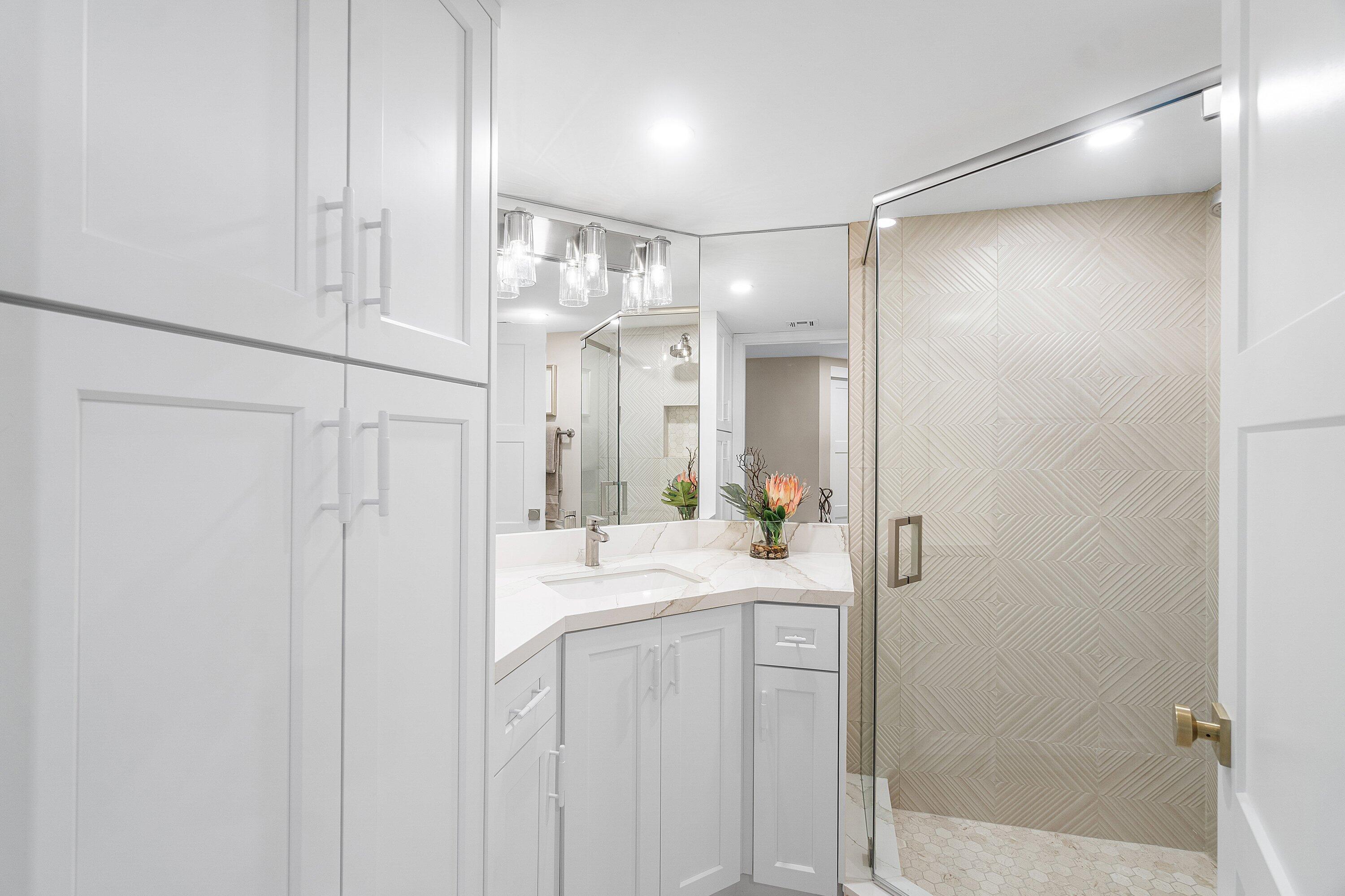 100 Southeast 5th Avenue, Unit 404 Boca Raton, FL 33432 - Photo 28 of 46 a bathroom with a double vanity sink mirror and shower