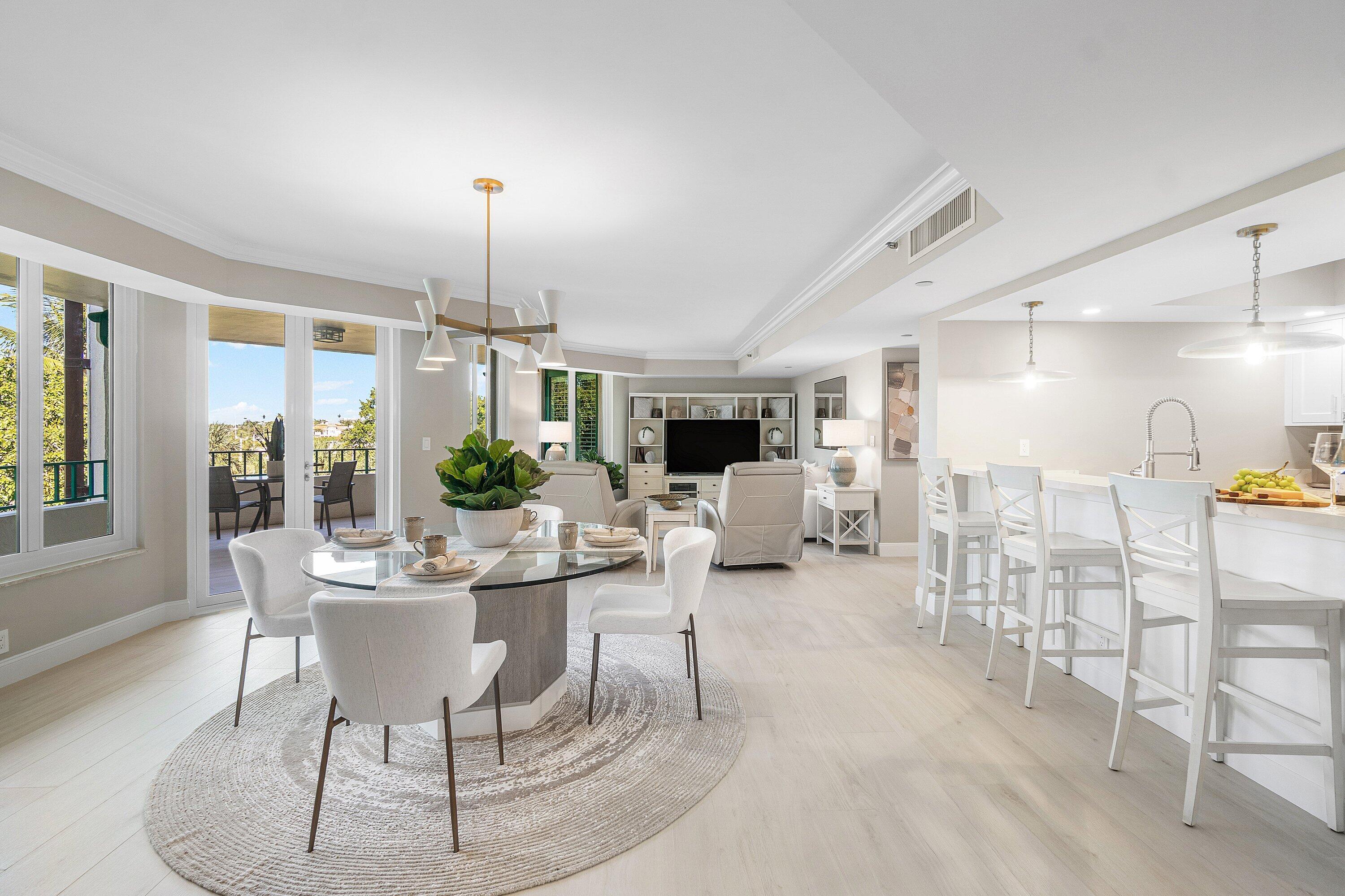 100 Southeast 5th Avenue, Unit 404 Boca Raton, FL 33432 - Photo 5 of 46 a dining room with furniture a chandelier and wooden floor
