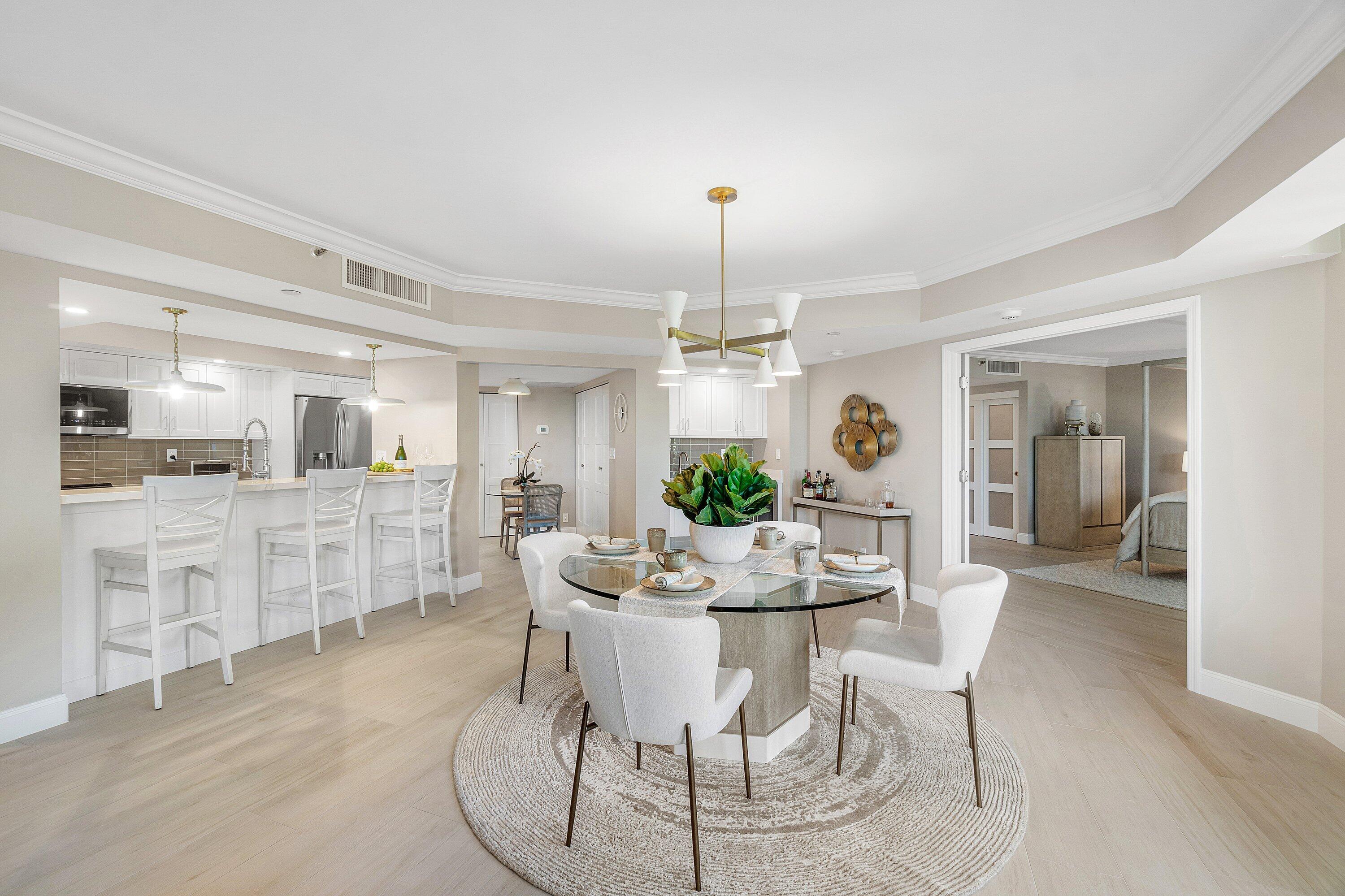 100 Southeast 5th Avenue, Unit 404 Boca Raton, FL 33432 - Photo 6 of 46 a dining room with furniture a chandelier and kitchen view