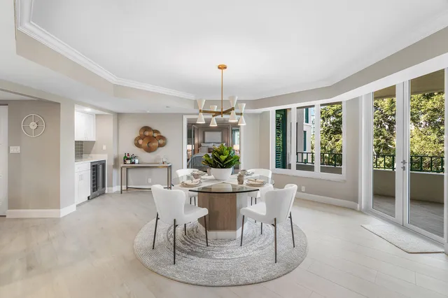 a kitchen with stainless steel appliances kitchen island granite countertop a table and chairs in it