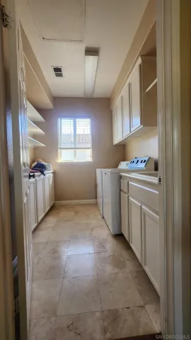 a view of a kitchen with storage and utility