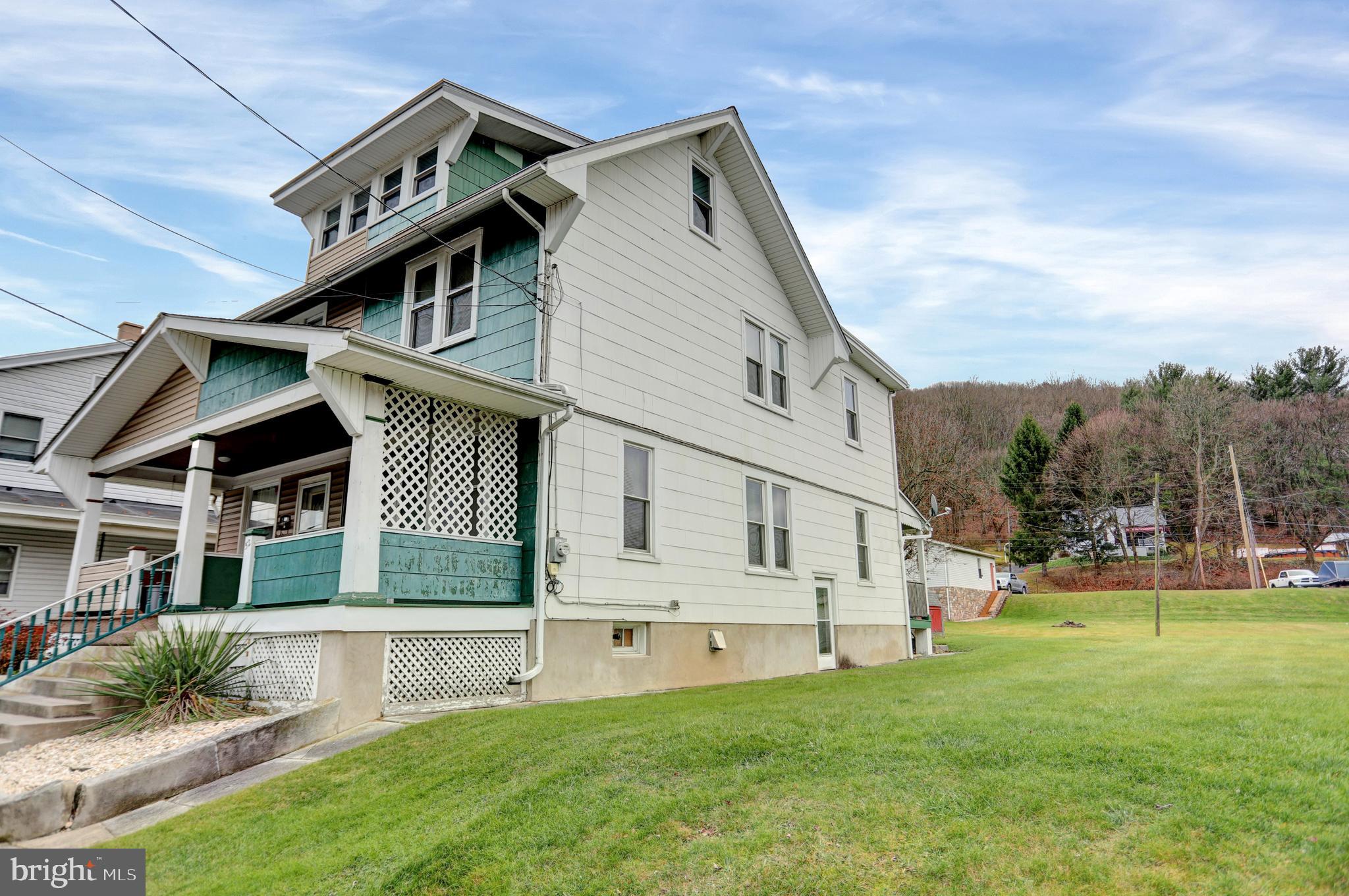 a view of house with yard