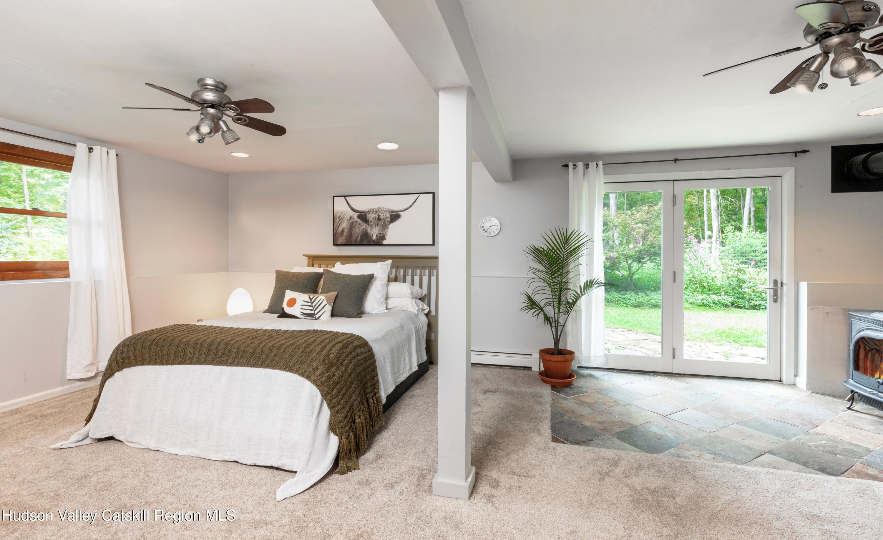 424 Tongore Way Kingston, NY 12401 - Photo 20 of 40 a bedroom with a bed and a chandelier