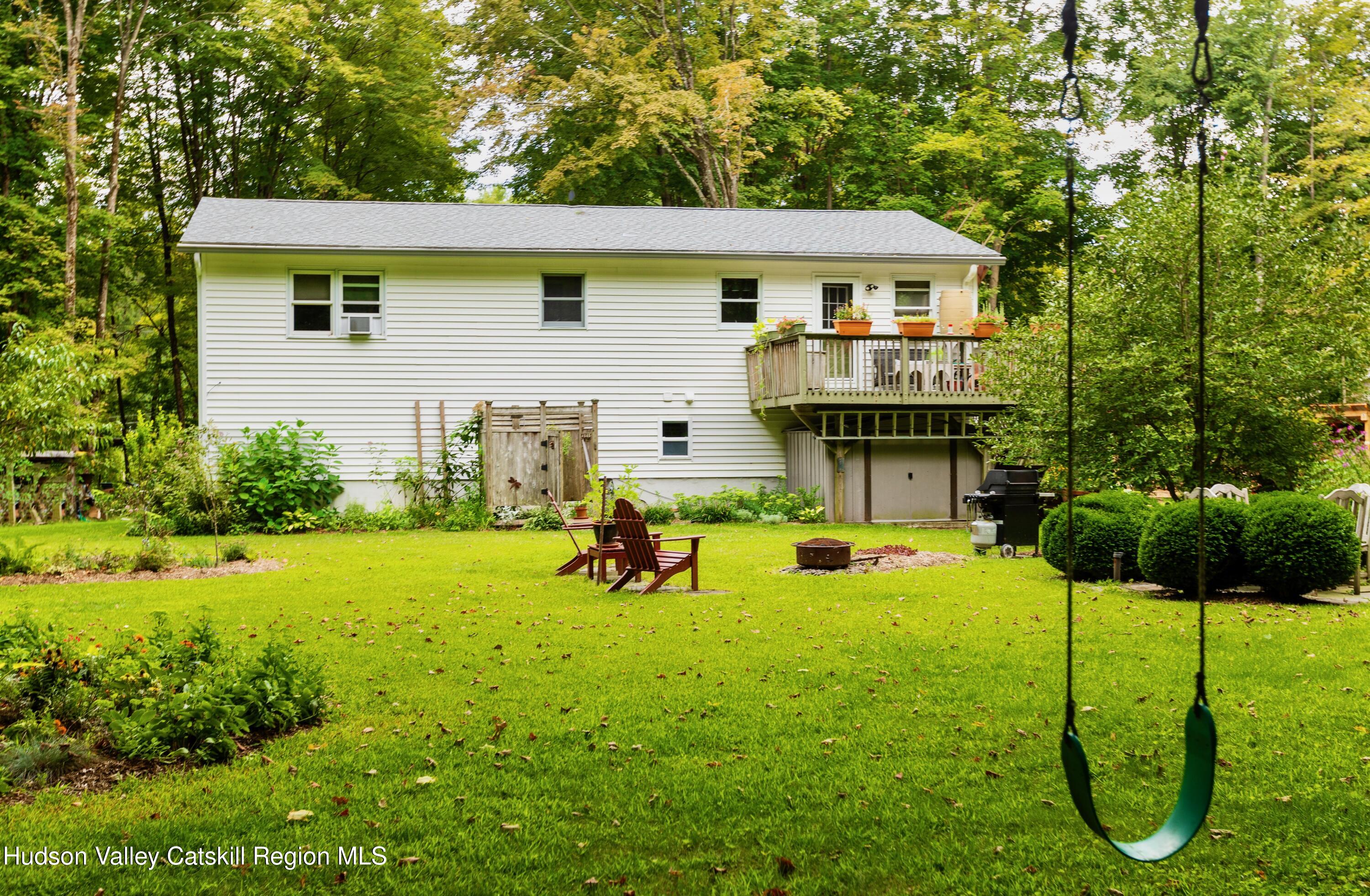 424 Tongore Way Kingston, NY 12401 - Photo 33 of 40 a view of a house with backyard sitting area and garden