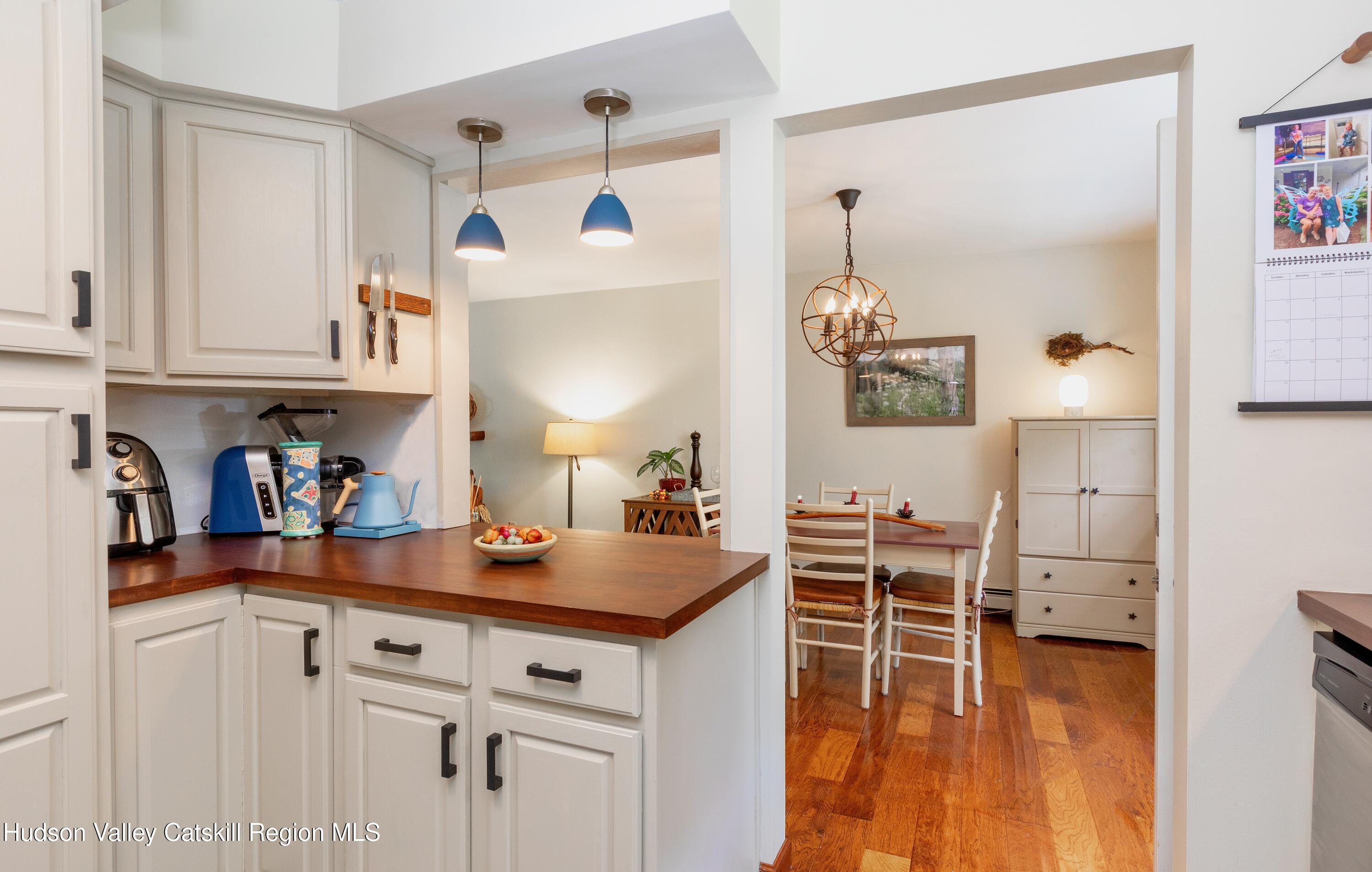 424 Tongore Way Kingston, NY 12401 - Photo 6 of 40 a kitchen with stainless steel appliances granite countertop a stove a sink and a refrigerator with white cabinets