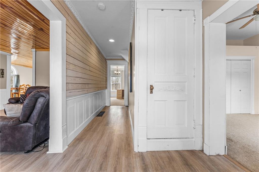 4400 Nye Road West Springfield, PA 16443 - Photo 16 of 31 a view of a hallway with wooden floor and furniture