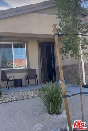 a room with a bench and potted plant