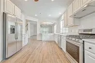 a kitchen with stainless steel appliances granite countertop a refrigerator and a stove