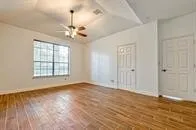 wooden floor in an empty room with a window