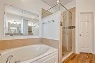 a bathroom with a bathtub and a shower
