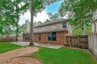 a view of a house with a yard and tree