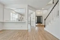 a view of kitchen with wooden floor and electronic appliances