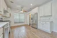 a view of a kitchen with granite countertop cabinets and wooden floor