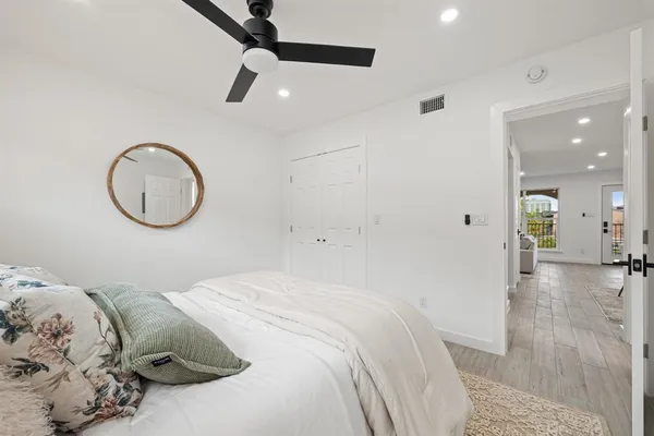 a bedroom with a bed and a chandelier