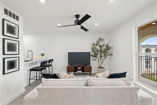 a living room with furniture and a flat screen tv