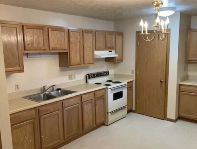 a kitchen with cabinets and stainless steel appliances