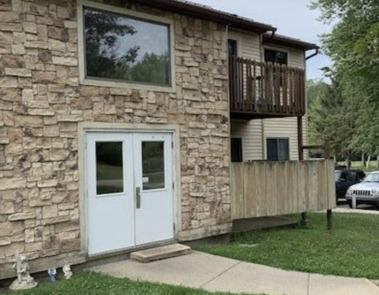 418 Cadillac Street Ligonier, IN 46767 - Photo 3 of 15 a front view of a house with a garden