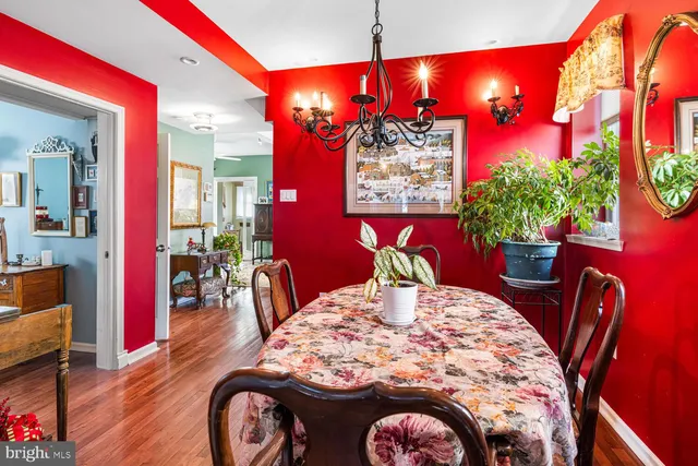 a view of a dining room with furniture and chandelier