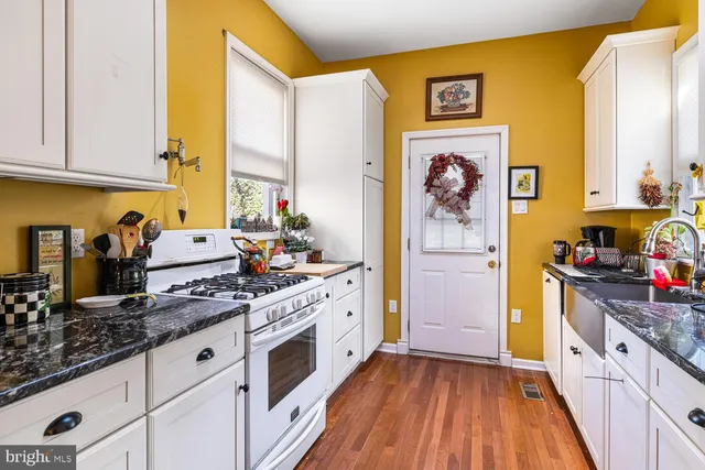 a kitchen with stainless steel appliances a stove a sink and a refrigerator